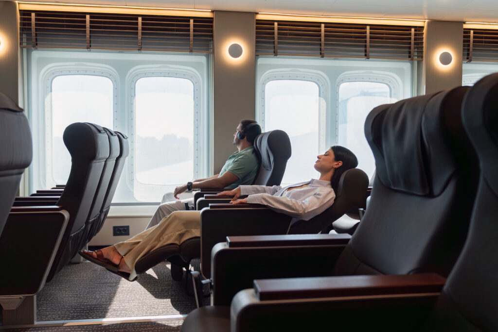 A woman in a ship of SEAJETS sitting in a bed vip rest seat