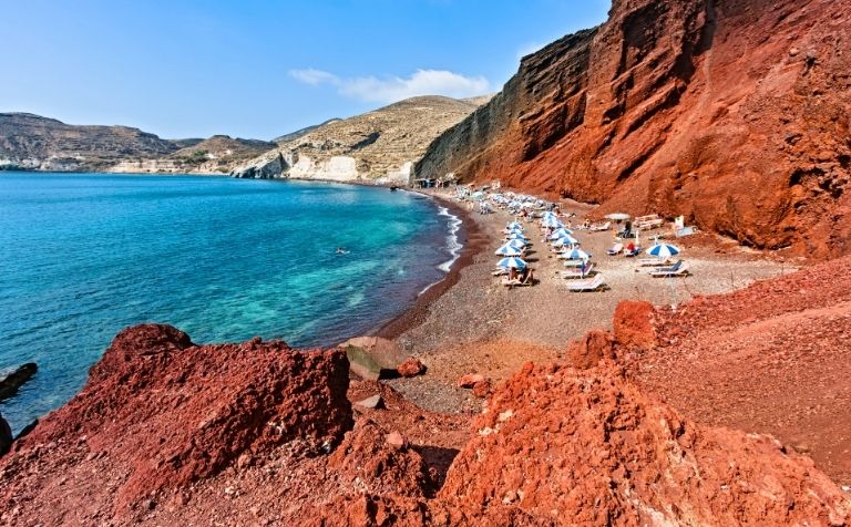 Santorini red beach sunbeds